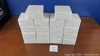 18 sealed white boxes of Teckin SPN10 smart plugs stacked on table