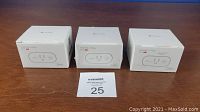 Lot of three sealed boxed Teckin SP20 Smart Wi-Fi Plugs on wooden surface with lot tag numbered 25