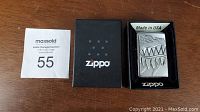 Zippo lighter in box with black Zippo box and auction tag