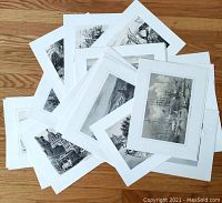 Collection of about 24 vintage matted prints of old Canada scenes, laid out on wooden floor