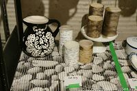 Overview photo of all items showing candles, pedestal, mat and black and white pitcher