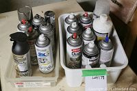 Two plastic bins with assorted spray paint cans; some with red spray nozzles, others in factory sealed condition. Includes brands Rust-Oleum and Krylon.