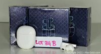 Photo of three boxed wireless earbud sets with one charging case and pair of earbuds outside one box for display