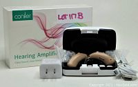 Coniler hearing amplifier with box, charging case, USB cable, and wall charger shown together