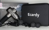 Photo showing the Ecardy massage gun, four interchangeable massage heads, charger, carrying case, and product box.
