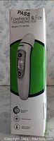 Front view of box showing the forehead and ear thermometer, model FC-JR100 with image of device and basic feature icons.