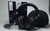 Vankyo wireless over-ear headphones shown with box, carrying case, and charging cable on a flat surface.