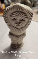 Front view of the carved soapstone figurine "Man" showing facial and clothing details.