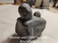 Front view of the soapstone 'Woman and Child' carving by Billy Kuniliusee showing the woman figure with child on back.