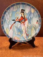 Front view of the collector's plate titled 'Thread of Sky' showing detailed painting of a Chinese woman, bird, and scenic background with decorative border.