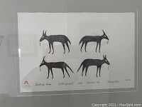 Frontal view of framed lithograph showing all four stylized dog figures on white paper.