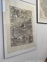 Framed Himalayan print hung on wall with detailed Tibetan script and symbolic imagery