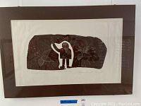 Full frontal view of framed lithograph on white wall