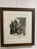 Framed art print showing the stone gateway Porte St. Louis in Quebec with an old car passing through, featuring color accents and a signature.