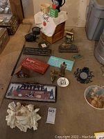Overview of lot from above showing various decorative items including angel figurines, wall art, cups, plaques, and bowl.