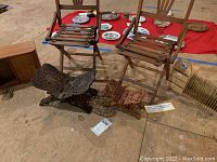 Two handmade vintage wooden collapsible children's chairs and two wooden collapsible book holders on floor