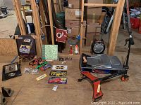Wide shot showing multiple items including Razor scooter, NASCAR and Hot Wheels memorabilia, commemorative license plates, and flags