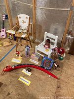 Overview of assorted toys including M&M's figurines, child/doll furniture, books, and assorted small toys.