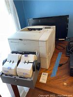 Photo of HP LaserJet 4000 printer, computer monitor, and Rolodex model 2400 on table