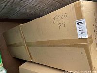 Two sealed cardboard cases containing multiple six-packs of paper towels with 115-sheet 2-ply rolls, labeled 'paper towels 2 cases'.