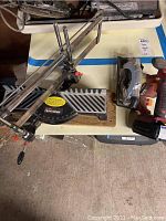Sears Craftsman cross-cut miter saw showing saw blade, measuring scale and adjustment handle