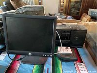 Front view of Dell LCD monitor and AIWA stereo radio cassette system with dual cassette decks on table.