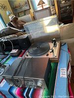 Stereo cassette deck and Thorens turntable on cloth-covered surface