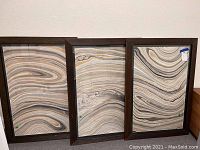 Three framed wall art pieces with abstract marble-like swirl patterns arranged side by side