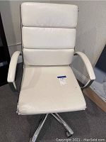 Front view of white leather office chair showing seat, backrest, armrests, and chrome base