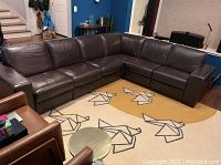 Full view of four-piece L-shaped sectional on area rug