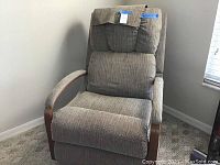 Front view of the swivel recliner showing fabric texture, padded cushions and wooden armrests.