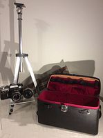 Photo showing Edixa Prismaflex TTL camera with lens mounted, Susis tripod standing, and open camera and tripod cases beside them.