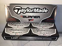 Front view of a large box containing 4 smaller boxes of TaylorMade Burner TP golf balls.