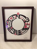 Frontal view of the Indigenous art circle depicting Raven and Killer Whale, showing the colors and design clearly.