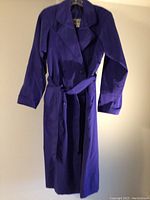 Front view of the vintage Ladea royal purply blue trench coat with belt.