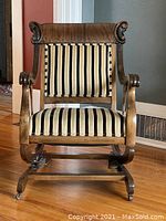 Front view of the wooden rocking armchair showing full frame and upholstery