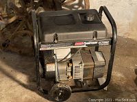 Front angle view of generator on steel frame with wheels and handle.