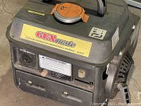 Front side of GenMate gasoline generator showing brand label and fuel cap