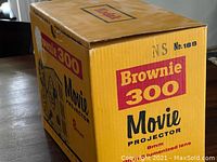 Original box for Kodak Brownie 300 Movie Projector 8mm with prominent yellow color and red/black text.