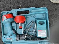 Makita cordless drill with charger inside blue plastic carrying case