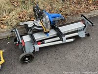 Folded saw on wheeled aluminum stand, side view