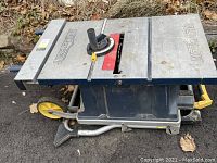 Side view of Mastercraft folding portable table saw on wheeled stand
