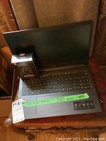 Open laptop showing keyboard and mouse box next to keyboard