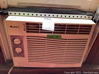 Gree window air conditioner front view with control knobs and ventilation grills, labeled 16x12 inches, with a note indicating it turns on