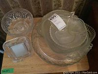 Top view of glass serving dishes and photo frame arranged on wooden surface