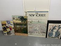 Four framed prints together: Playbill collage, Van Gogh in Arles, The New Yorker cover, Vogue cover with broken glass visible