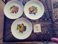 3 dessert plates showing pear & blackberry, peach & cherry, and quince & plum designs.