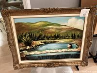 Frontal view of the original oil painting showing the full Greek landscape scene with hills, trees, water, and sky, framed in an ornate decorative golden frame.