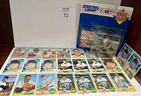 Wide shot showing multiple vintage 1960s baseball trading cards laid out in rows and the boxed 1995 Starting Lineup Cecil Fielder figurine with card.