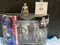 Packaged commemorative Star Wars Episode V The Empire Strikes Back DVD collection with four action figures including Han Solo, Chewbacca, and Stormtrooper visible through clear plastic window on colorful outer box.
